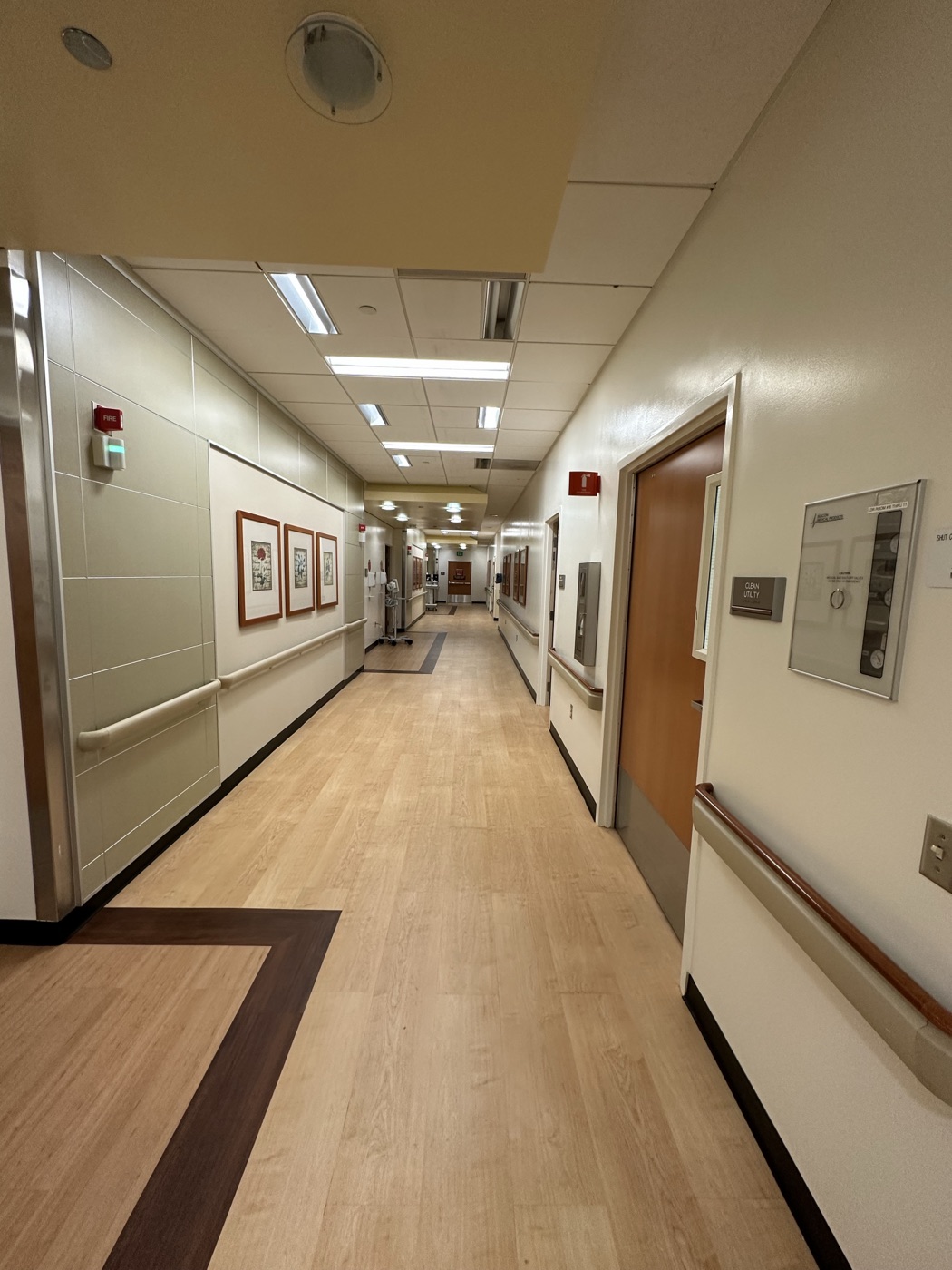 Renovated hospital corridor at Torrance Memorial with new flooring, handrails, and wall protection completed around active operations