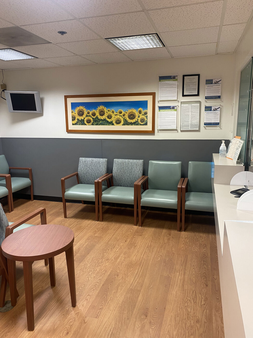 Renovated hospital patient waiting area with new flooring, seating, and wall finishes